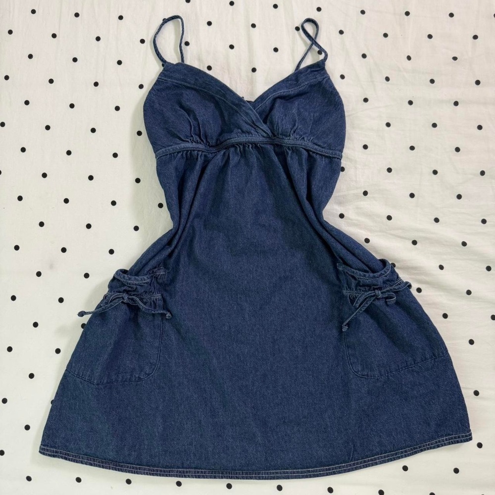 Navy Y2K denim mini dress with adjustable straps,‎ pockets, and tie detail
